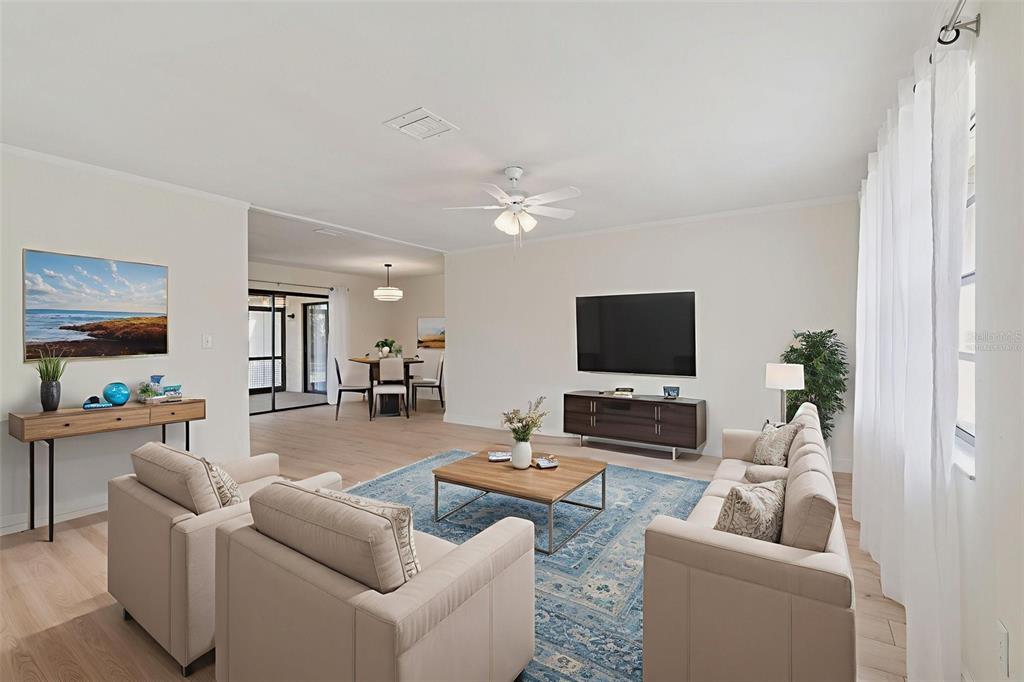 7337 Cambridge Way Clearwater, FL 33764 - Photo 3 of 28 a living room with furniture and a flat screen tv