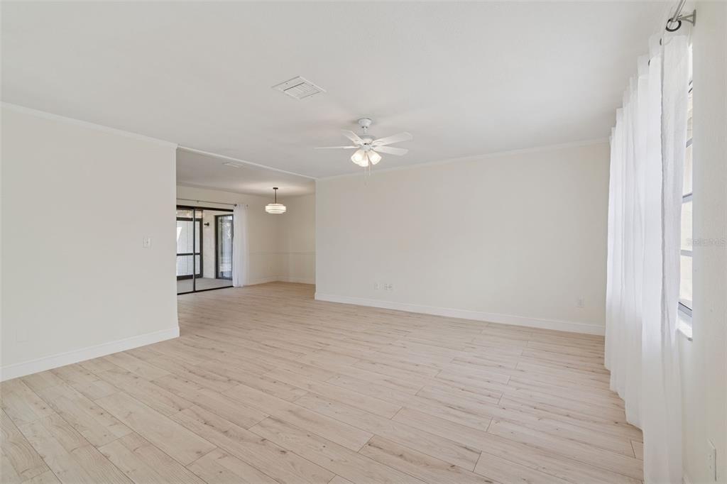 7337 Cambridge Way Clearwater, FL 33764 - Photo 4 of 28 wooden floor in an empty room