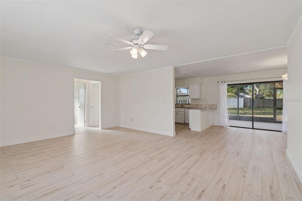7337 Cambridge Way Clearwater, FL 33764 - Photo 6 of 28 a view of an empty room with a window and wooden floor