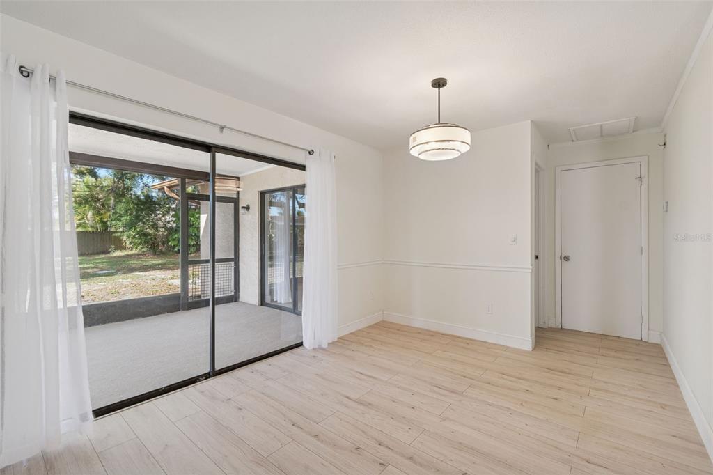7337 Cambridge Way Clearwater, FL 33764 - Photo 10 of 28 wooden floor in an empty room with a window