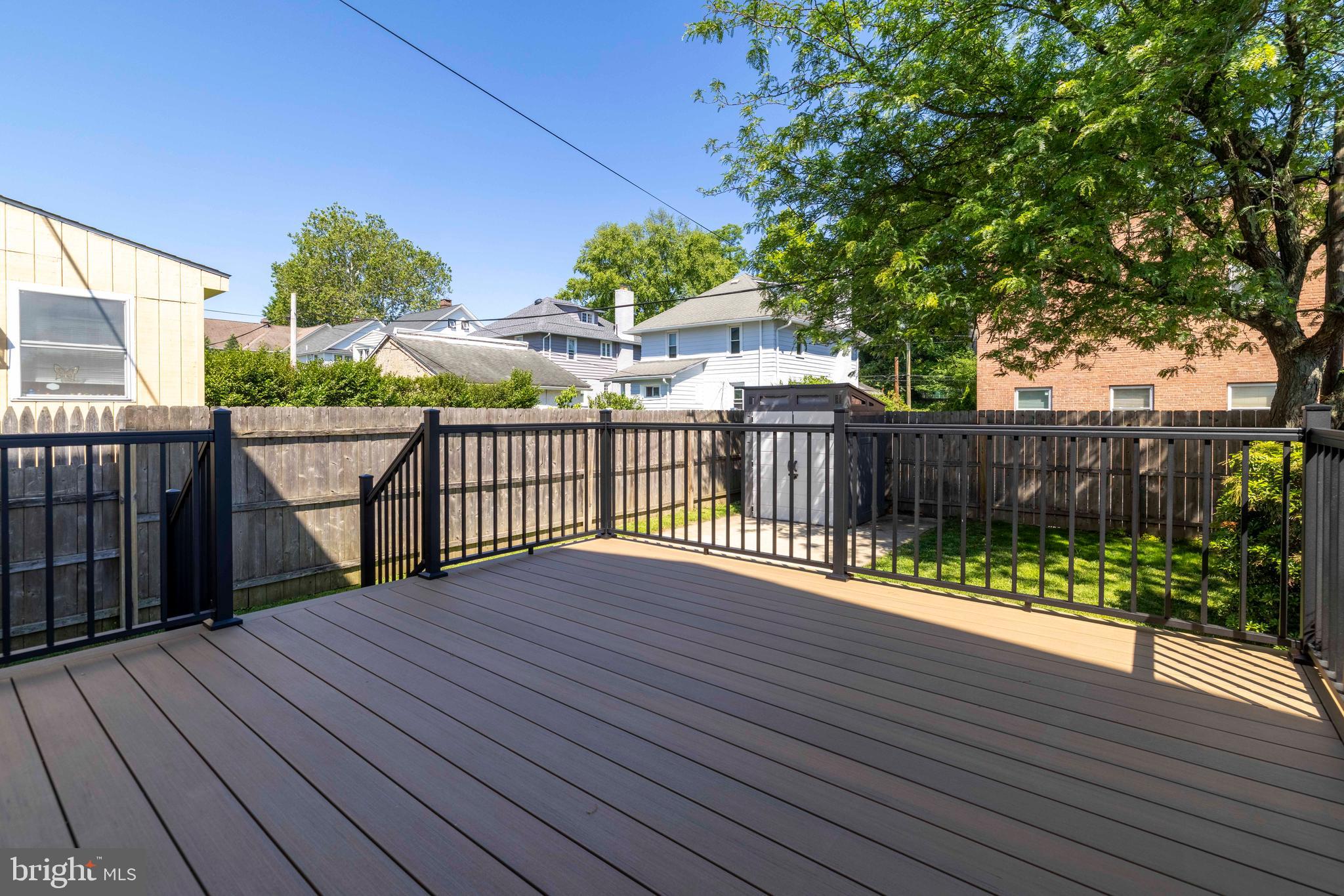 229 Wayne Avenue Narberth, PA 19072 - Photo 31 of 35 a view of deck with wooden floor and fence next to a yard