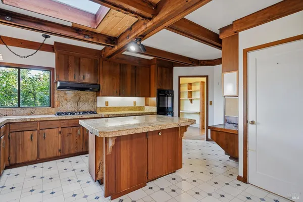a kitchen with a stove a sink and a refrigerator