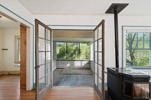 a view of hallway with a large window and wooden floor