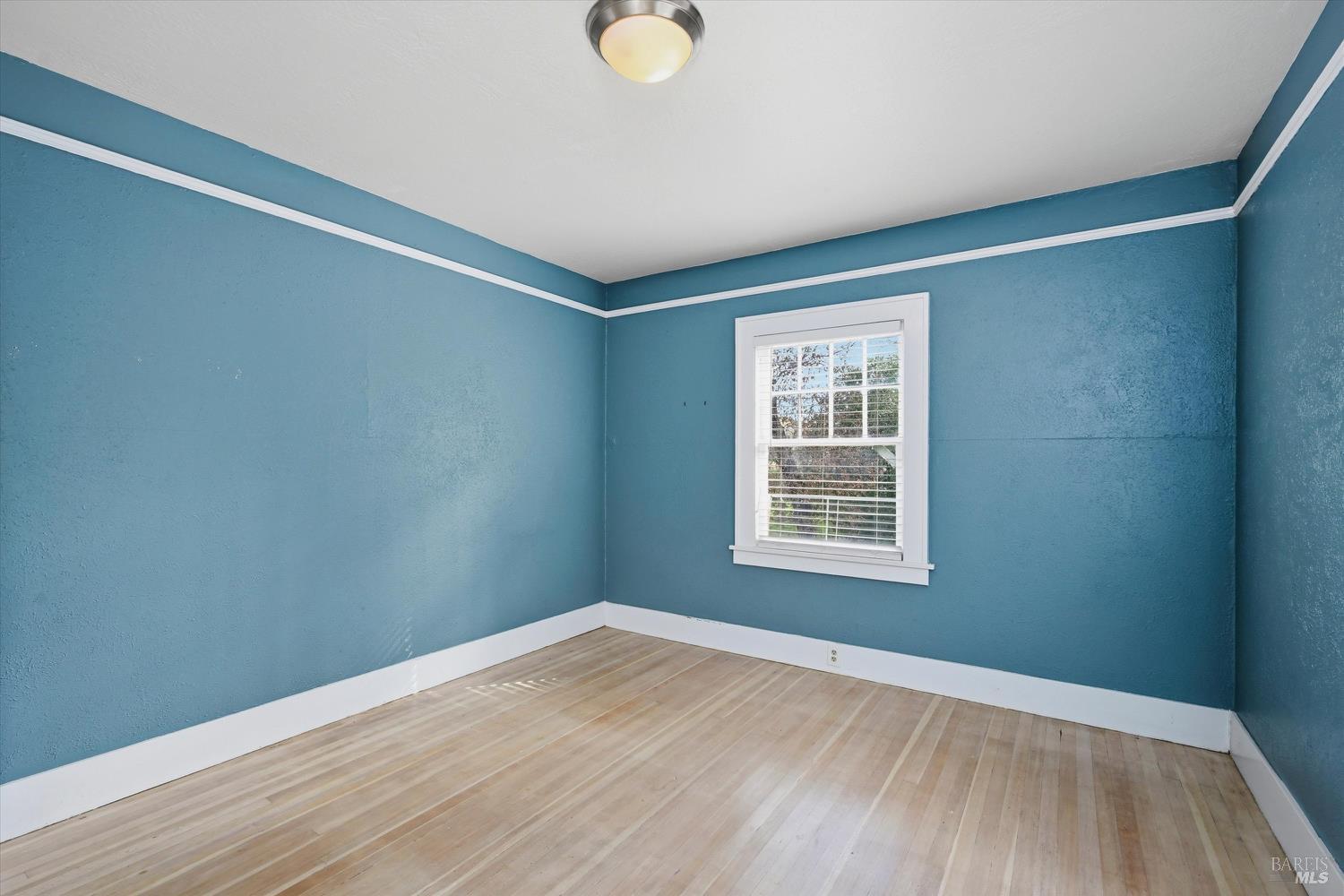 1830 Howell Mountain Road St. Helena, CA 94574 - Photo 16 of 33 a view of an empty room with wooden floor and a window