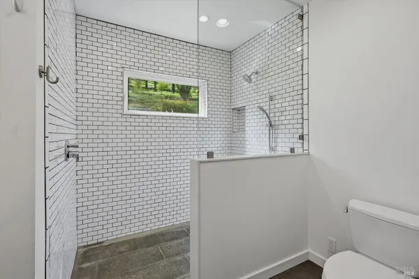 a bathroom with a toilet and a shower