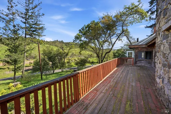 a view of balcony with wooden floor and fence
