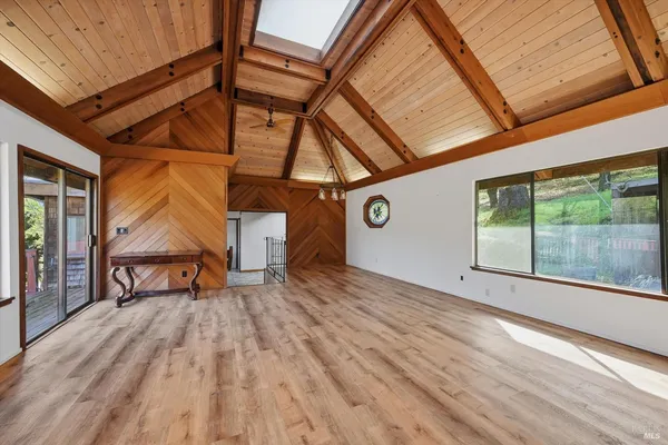 a view of a room with wooden floor and iron stairs