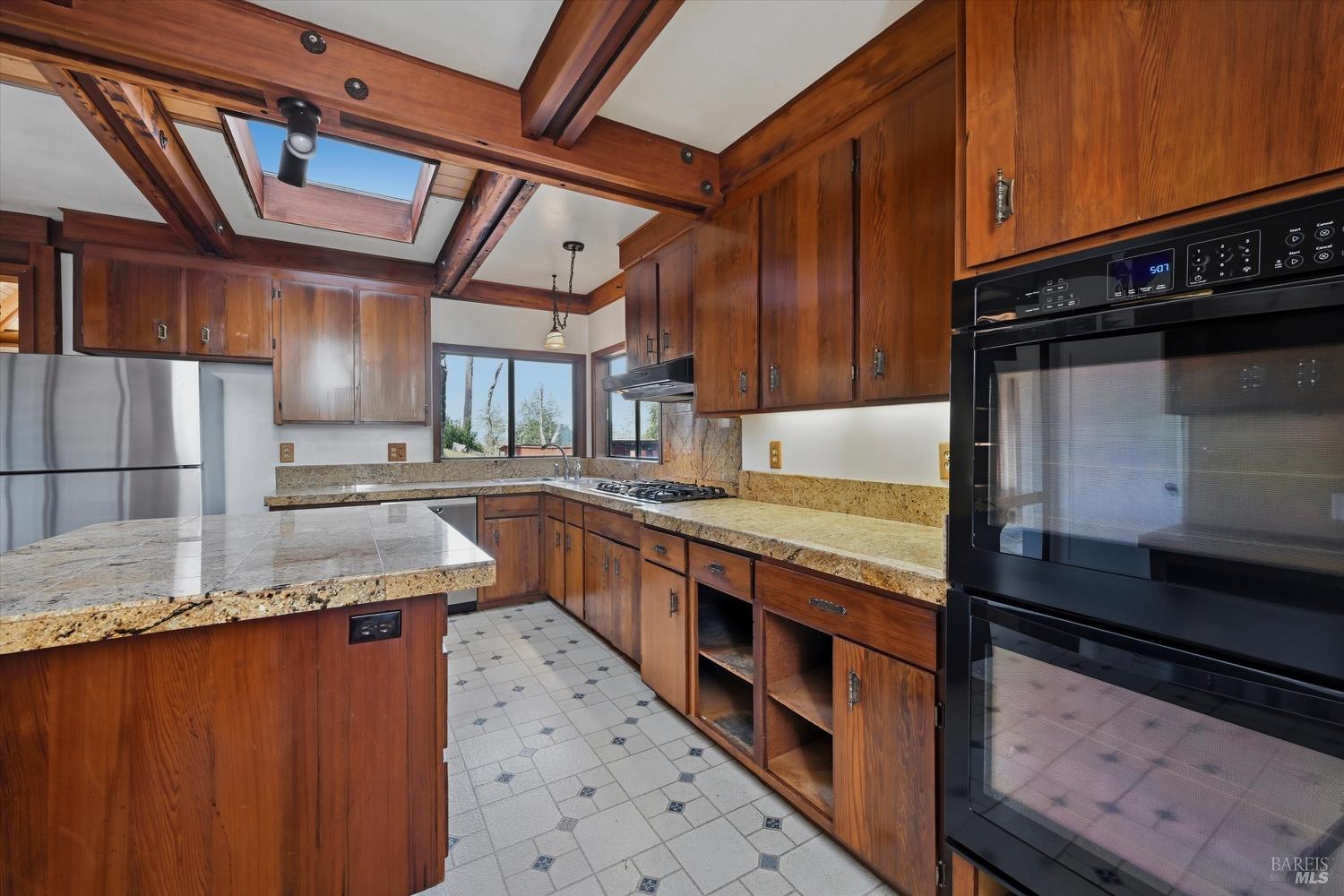1830 Howell Mountain Road St. Helena, CA 94574 - Photo 10 of 33 a kitchen with stainless steel appliances granite countertop a stove a sink and a microwave