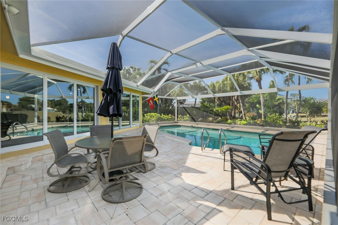 1264 Par View Drive Sanibel, FL 33957 - Photo 18 of 50 a view of a patio with a dining table and chairs