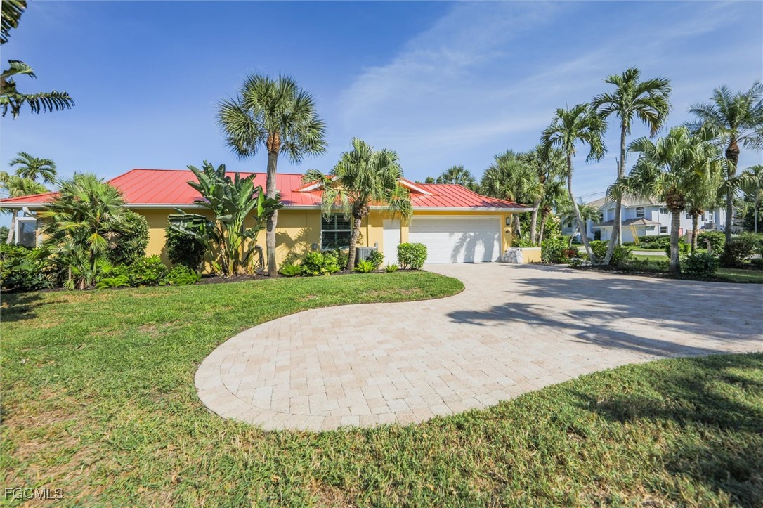 1264 Par View Drive Sanibel, FL 33957 - Photo 29 of 50 a front view of a house with a yard and potted plants