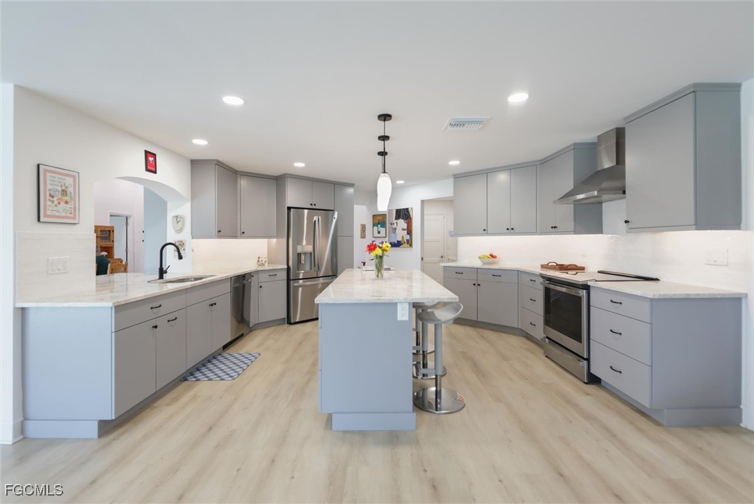 1264 Par View Drive Sanibel, FL 33957 - Photo 3 of 50 a large kitchen with a large counter top a sink stainless steel appliances and cabinets