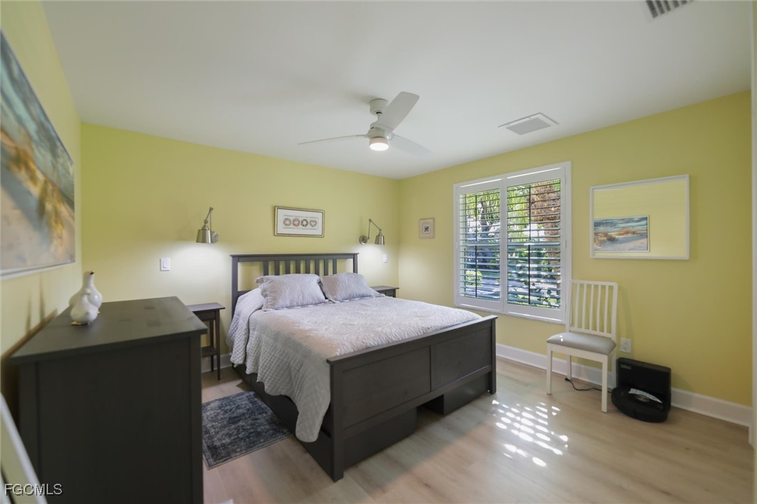 1264 Par View Drive Sanibel, FL 33957 - Photo 47 of 50 a bedroom with a bed and wooden floor
