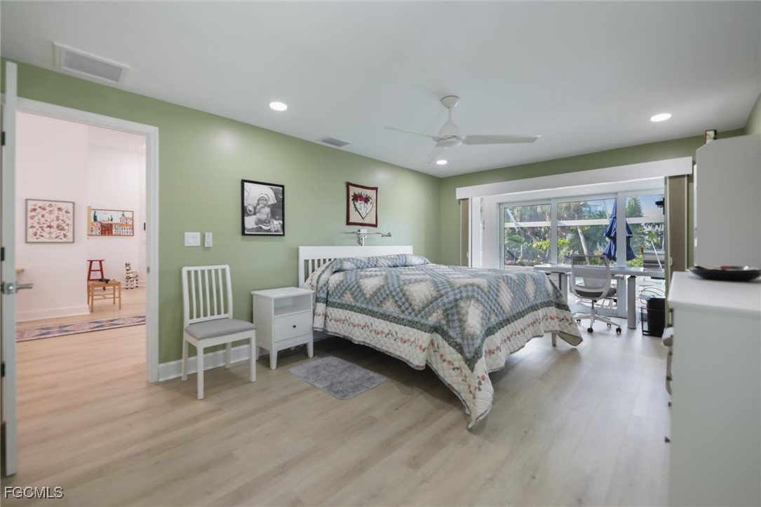 1264 Par View Drive Sanibel, FL 33957 - Photo 7 of 50 a bedroom with a bed large window and a flat screen tv