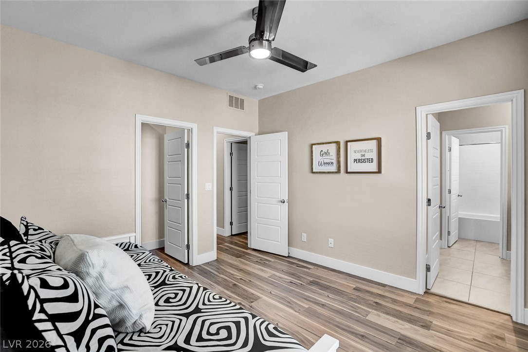 9688 Rankin Rdg Court Las Vegas, NV 89178 - Photo 31 of 53 Streamlined wood flooring extends into this well-lit room, featuring a modern ceiling fan for comfort.