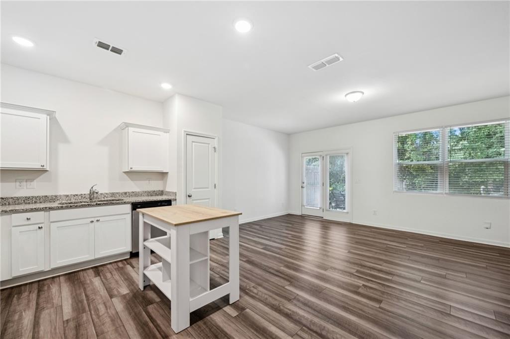 1653 Vernon Boulevard Decatur, GA 30035 - Photo 4 of 24 a kitchen with granite countertop a stove top oven sink and wooden floor