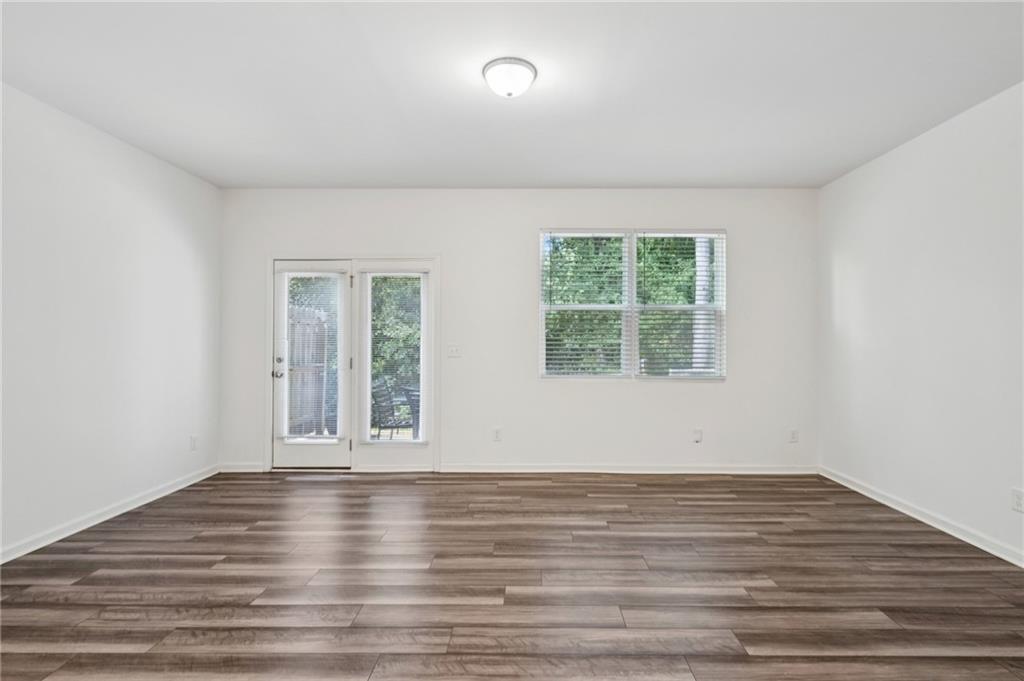 1653 Vernon Boulevard Decatur, GA 30035 - Photo 5 of 24 a view of empty room with wooden floor and fan