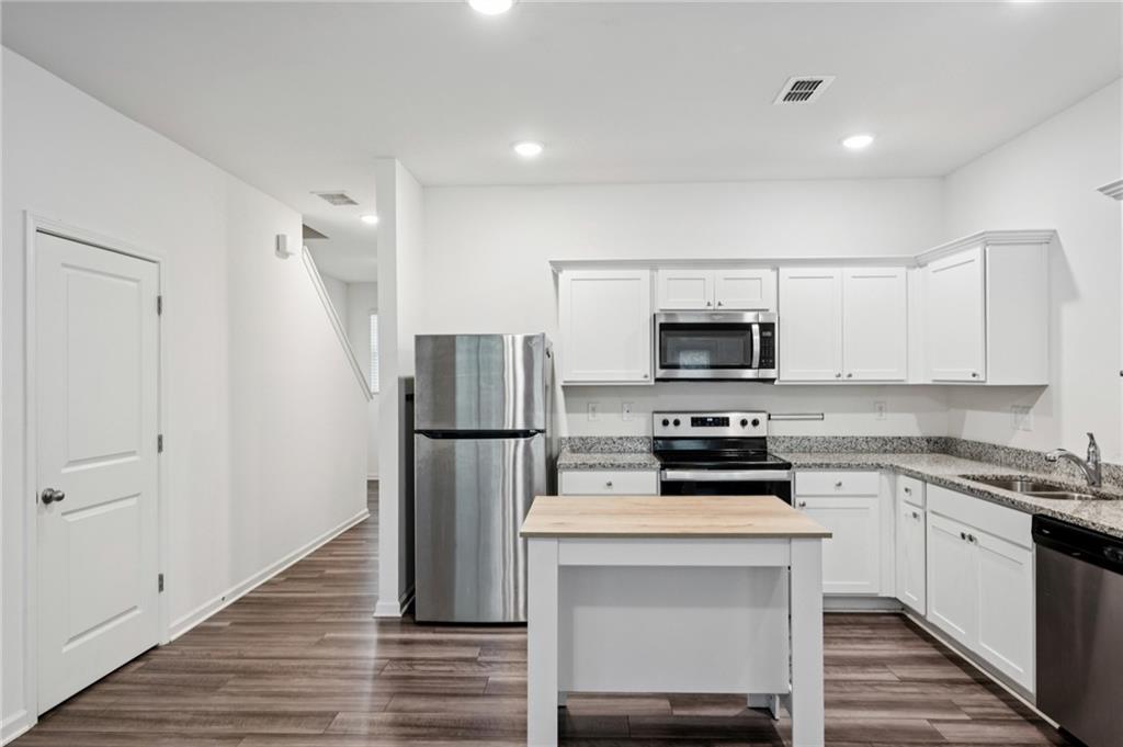 1653 Vernon Boulevard Decatur, GA 30035 - Photo 8 of 24 a kitchen with a white stove and refrigerator