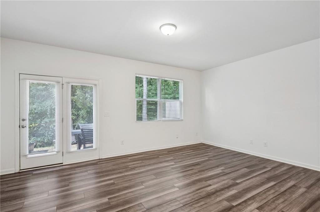 1653 Vernon Boulevard Decatur, GA 30035 - Photo 9 of 24 a view of an empty room with wooden floor and a window