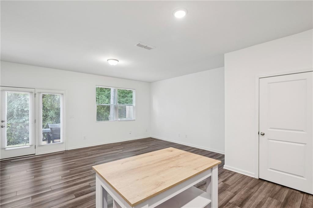 1653 Vernon Boulevard Decatur, GA 30035 - Photo 10 of 24 an empty room with wooden floor and windows