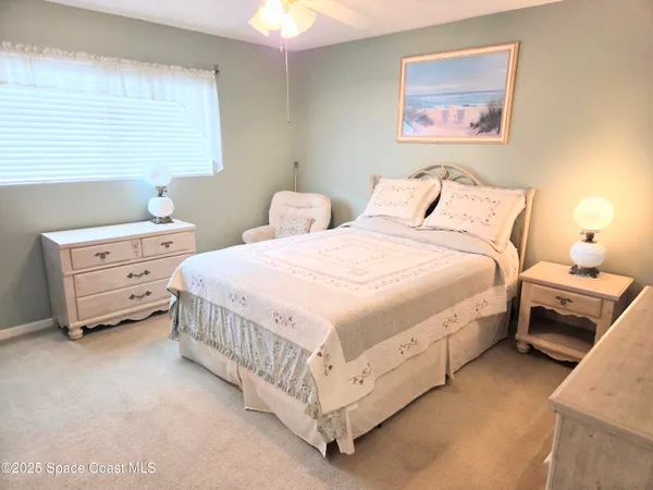 a bedroom with bed and a window