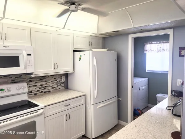 a kitchen with refrigerator and window