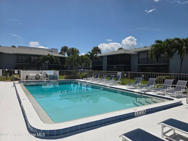 a swimming pool with outdoor seating and yard