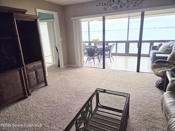 a view of livingroom with furniture and floor to ceiling window