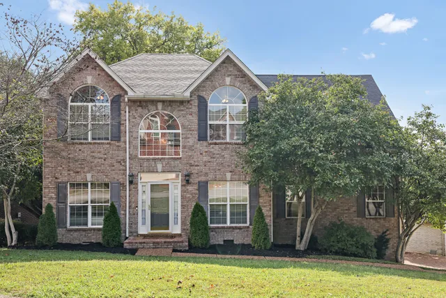 a front view of a house with a yard