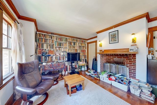 a living room with fireplace furniture and a flat screen tv