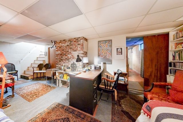 a view of a livingroom with furniture and a window