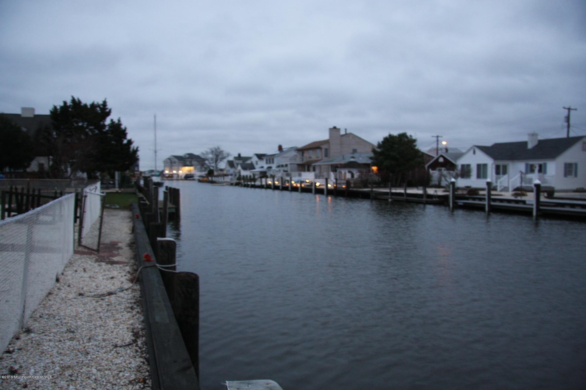 731 Drum Point Road Brick, NJ 08723 - Photo 3 of 11 a view of a lake with boats and trees in the background