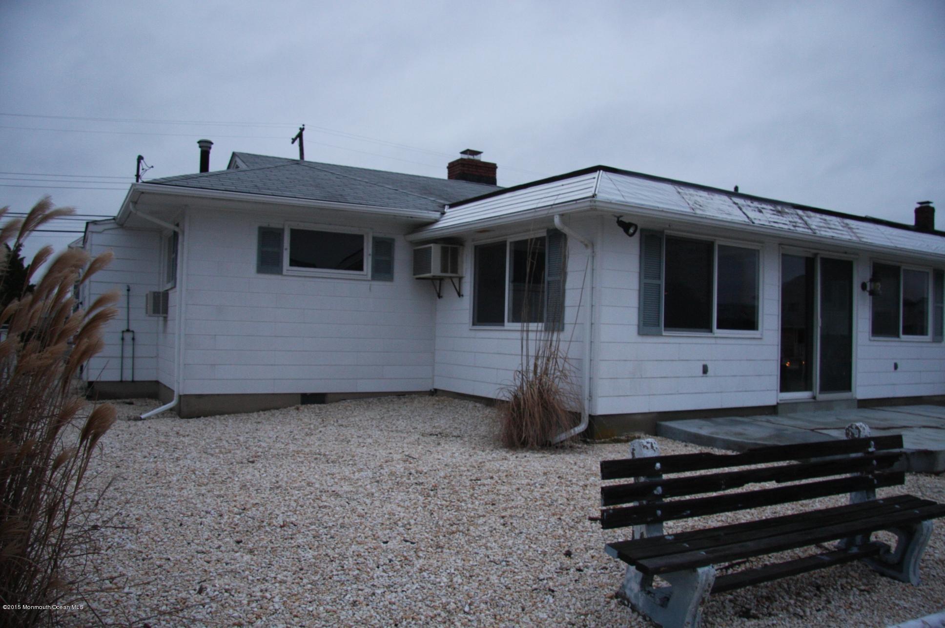 731 Drum Point Road Brick, NJ 08723 - Photo 4 of 11 a view of a house with a flat bed and a window