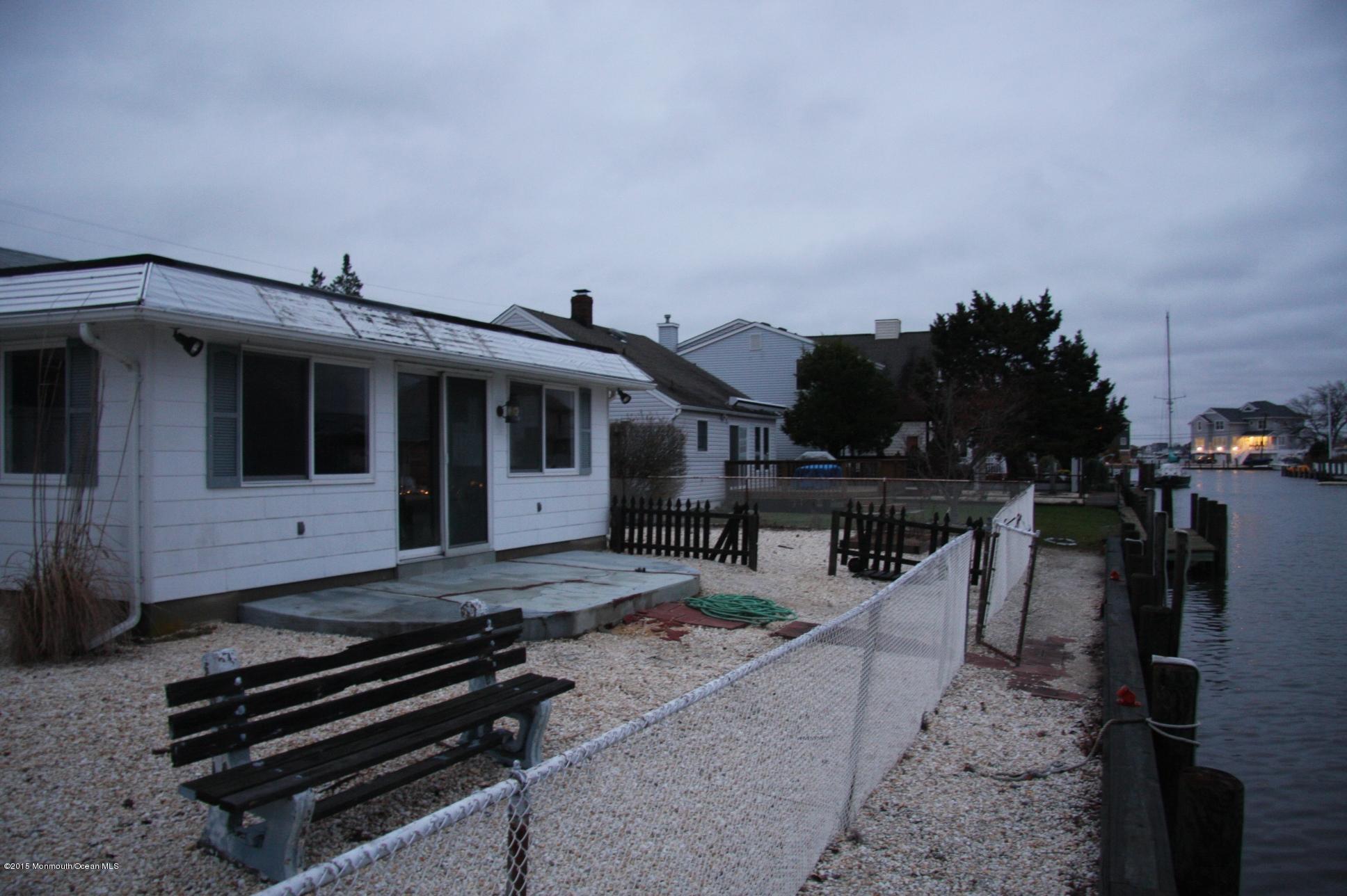 731 Drum Point Road Brick, NJ 08723 - Photo 6 of 11 a roof deck with table and chairs a barbeque