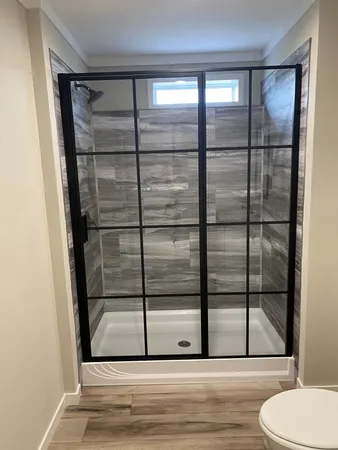 a bathroom with a glass shower door