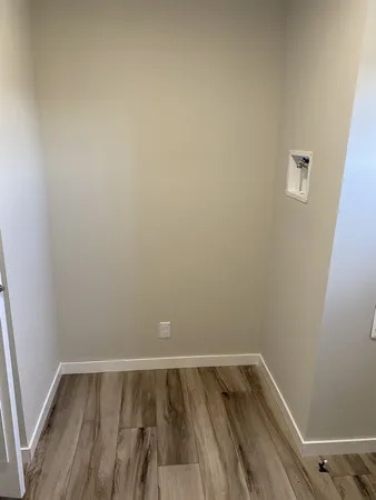 a view of a room with wooden floor and window