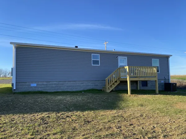 a view of a house with a yard and sitting area