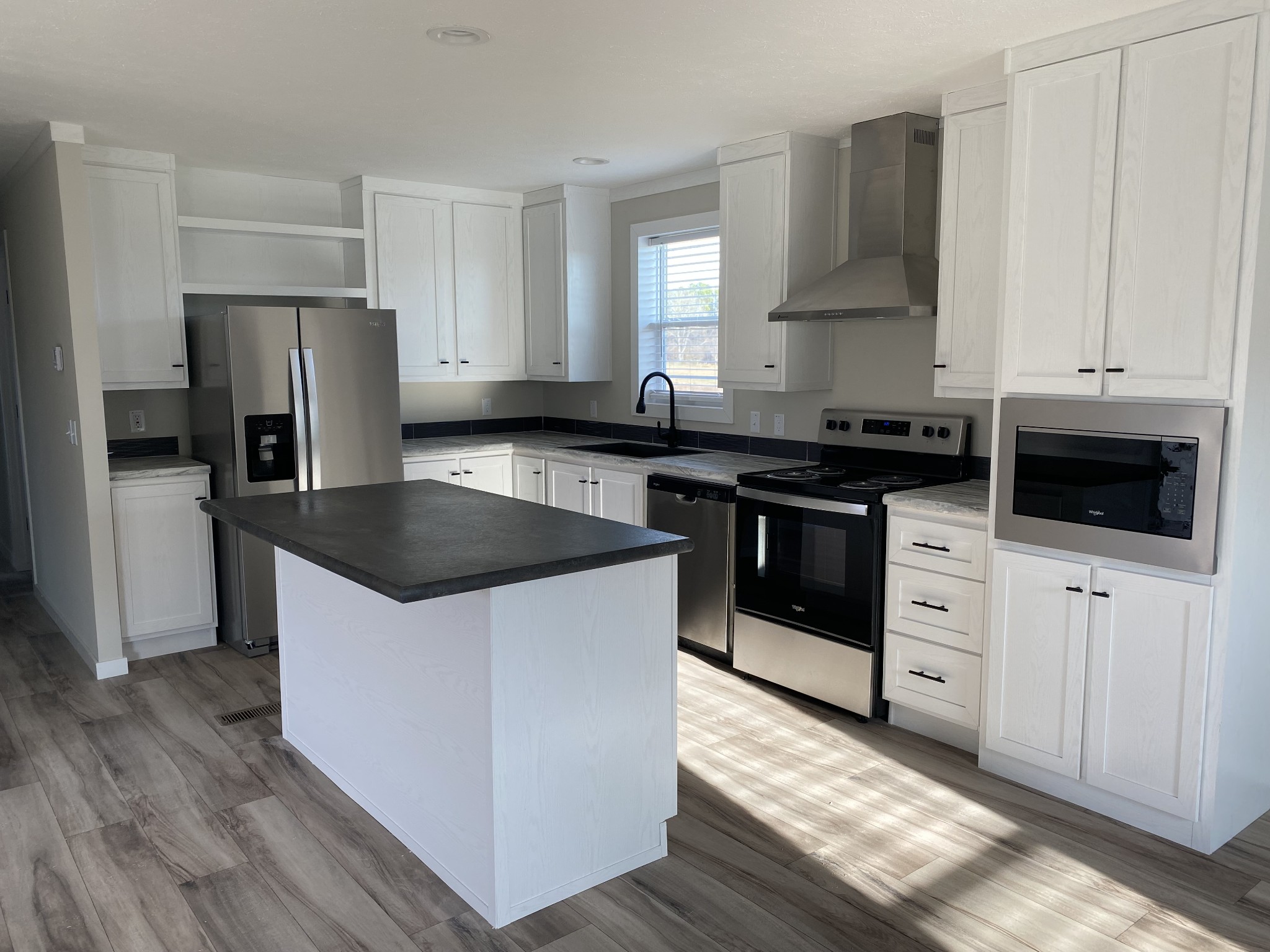 1710 Gamaliel Road Red Boiling Springs, TN 37150 - Photo 6 of 24 a kitchen with stainless steel appliances a stove a sink and a refrigerator
