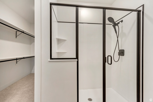 1389 1440 East, Unit 1 Payson, UT 84651 - Photo 11 of 17 Walk-in shower with black-framed glass enclosure, matte black shower fixtures, and integrated shelving