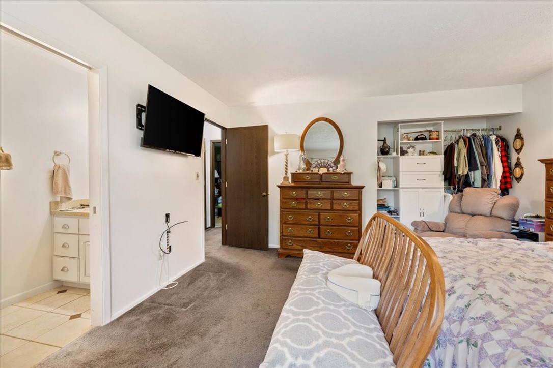 7225 Garber Road Clayton, OH 45415 - Photo 15 of 33 This spacious bedroom offers ample storage, cozy carpeting, and convenient access to the adjoining bathroom.