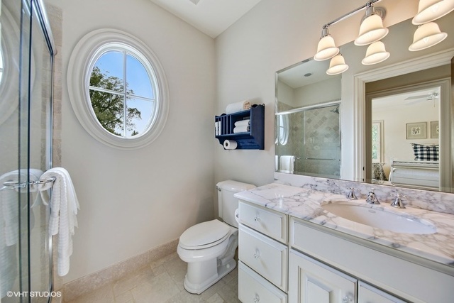 607 West Maple Street Hinsdale, IL 60521 - Photo 25 of 59 a bathroom with a granite countertop toilet a sink and a mirror
