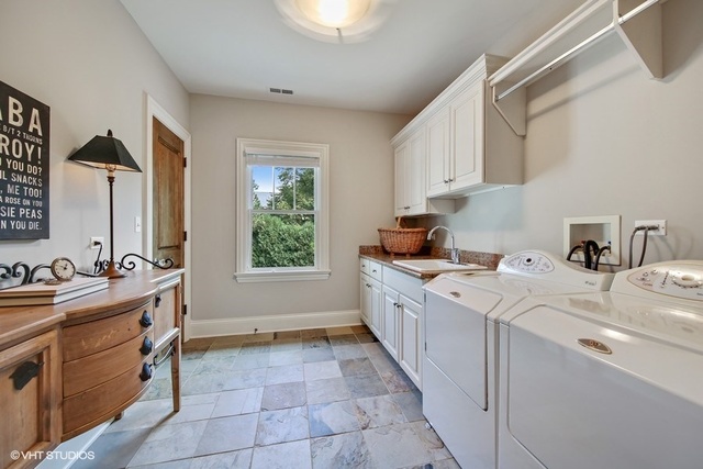 607 West Maple Street Hinsdale, IL 60521 - Photo 29 of 59 a kitchen that has a sink and a stove in it