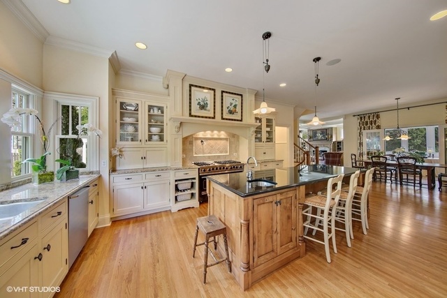 607 West Maple Street Hinsdale, IL 60521 - Photo 9 of 59 a kitchen with stainless steel appliances a table and chairs in it