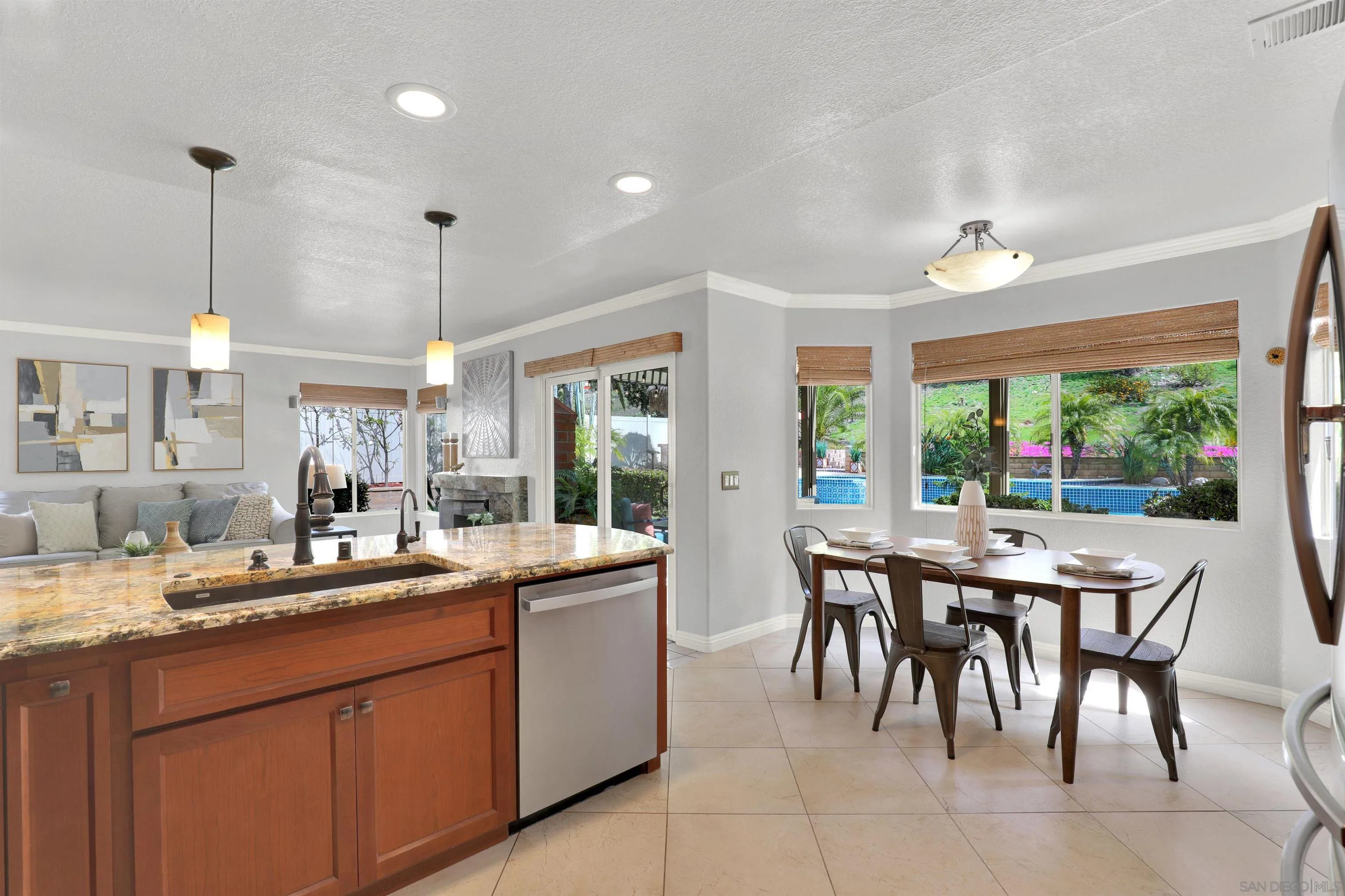 13901 Carriage Road Poway, CA 92064 - Photo 11 of 37 a dining hall with stainless steel appliances granite countertop a sink a stove a dining table and chairs