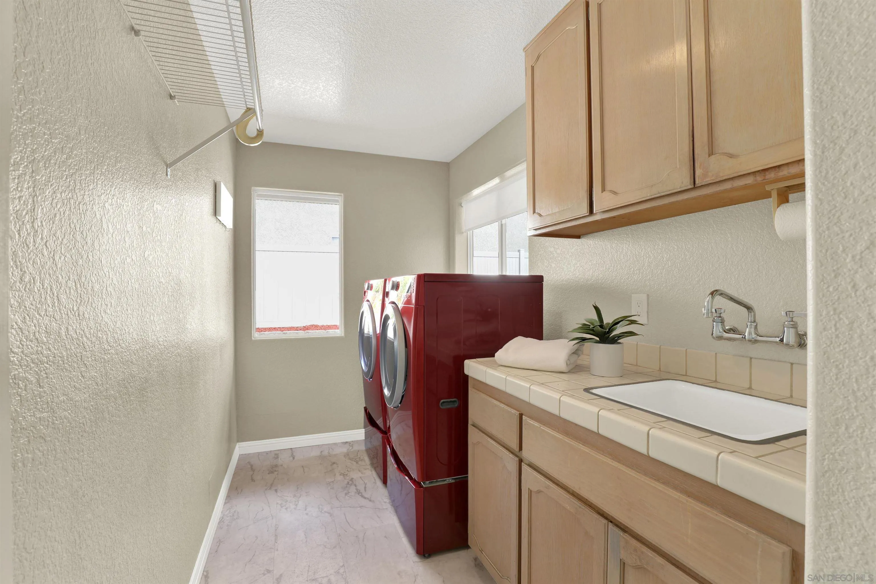 13901 Carriage Road Poway, CA 92064 - Photo 16 of 37 a room with refrigerator and cabinets