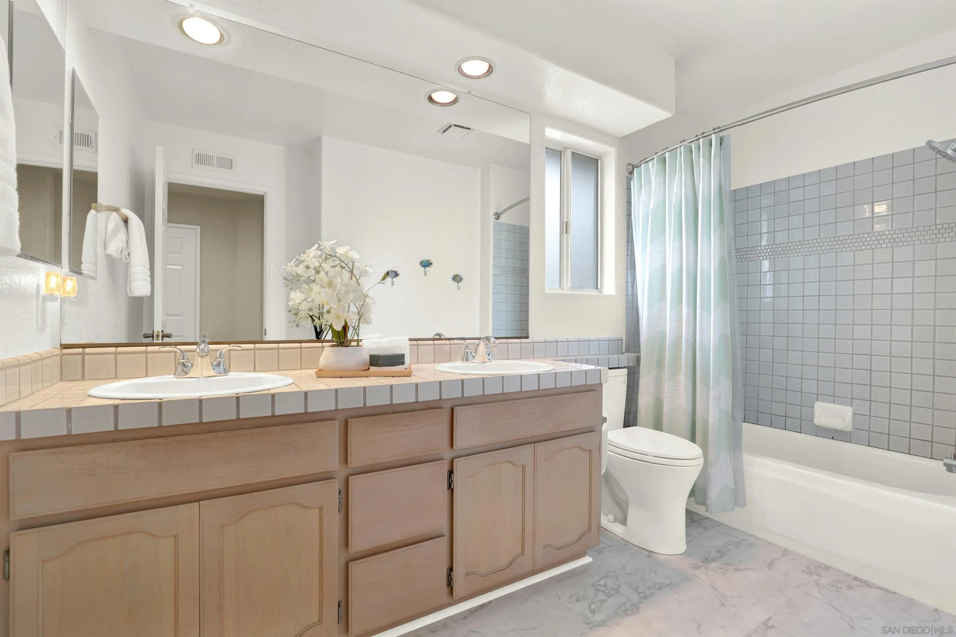 13901 Carriage Road Poway, CA 92064 - Photo 23 of 37 a bathroom with a double vanity sink toilet and shower