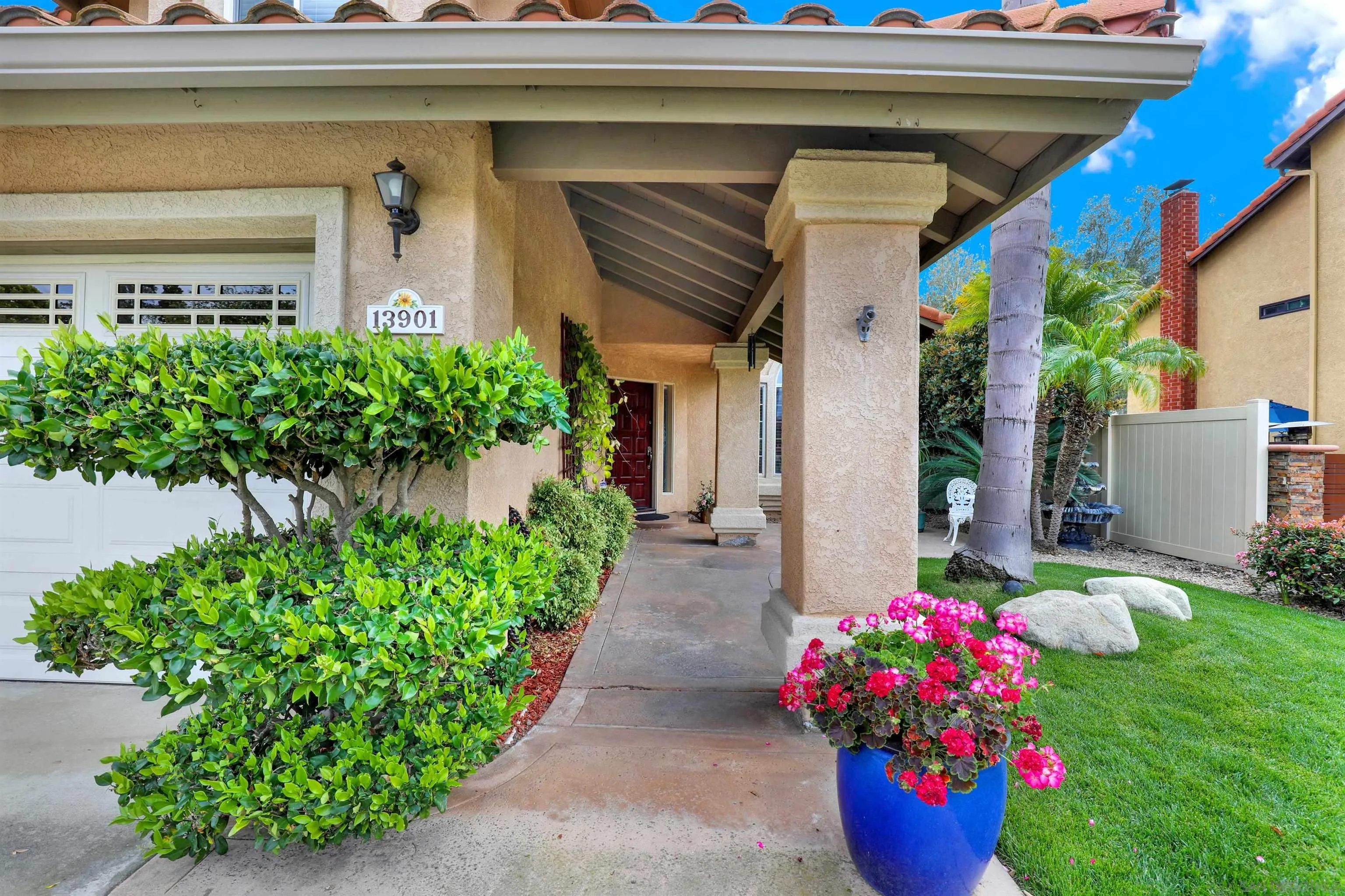 13901 Carriage Road Poway, CA 92064 - Photo 3 of 37 a house with a yard and a potted plant