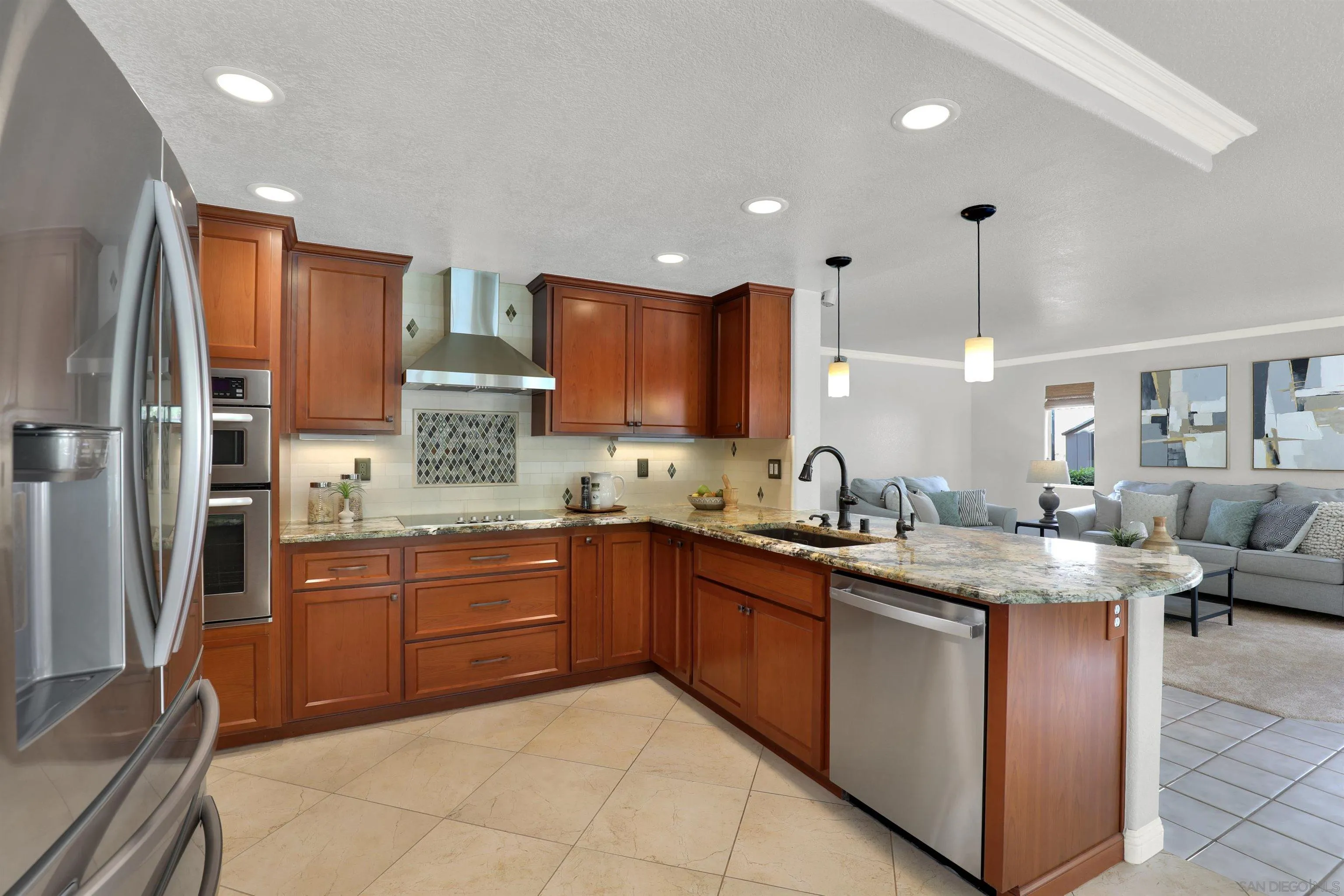 13901 Carriage Road Poway, CA 92064 - Photo 10 of 37 a kitchen with stainless steel appliances granite countertop wooden cabinets a sink dishwasher a stove and a refrigerator