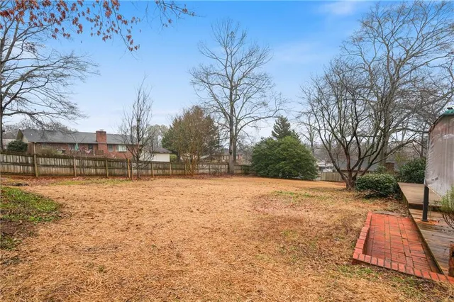 a front view of house with yard and trees around