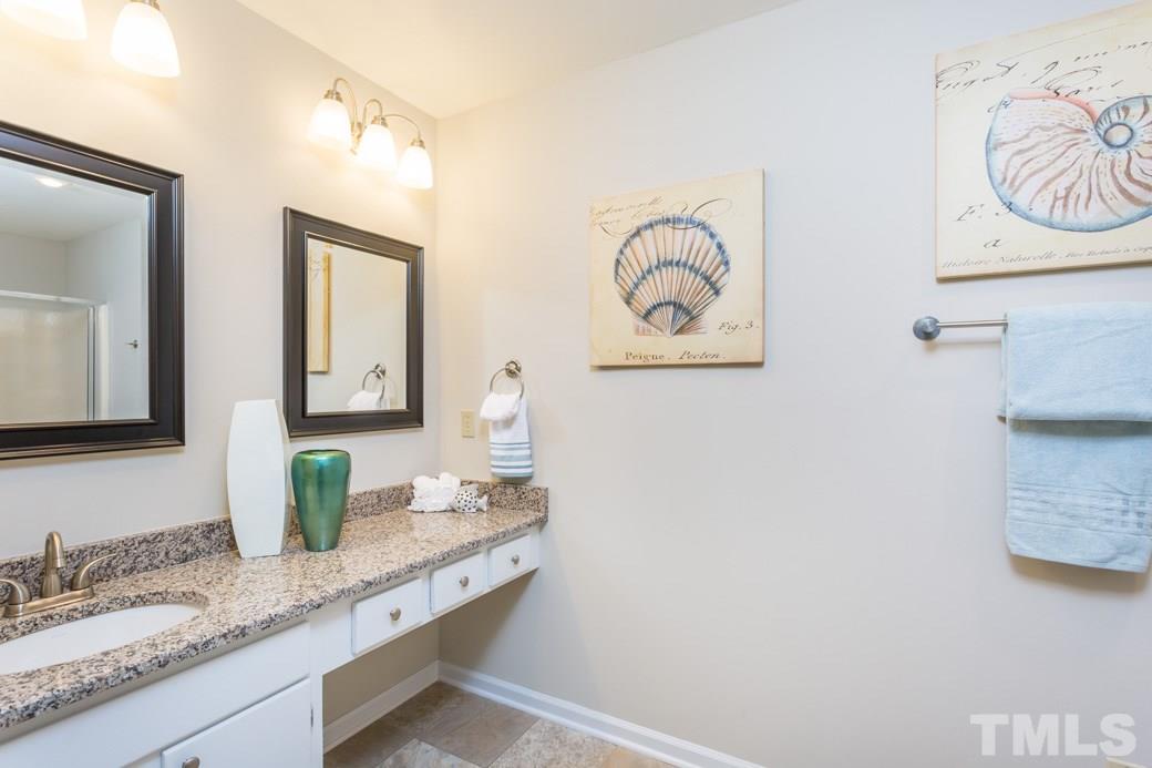 2804 Kempsford Place Raleigh, NC 27604 - Photo 4 of 11 a bathroom with a granite countertop sink and a mirror