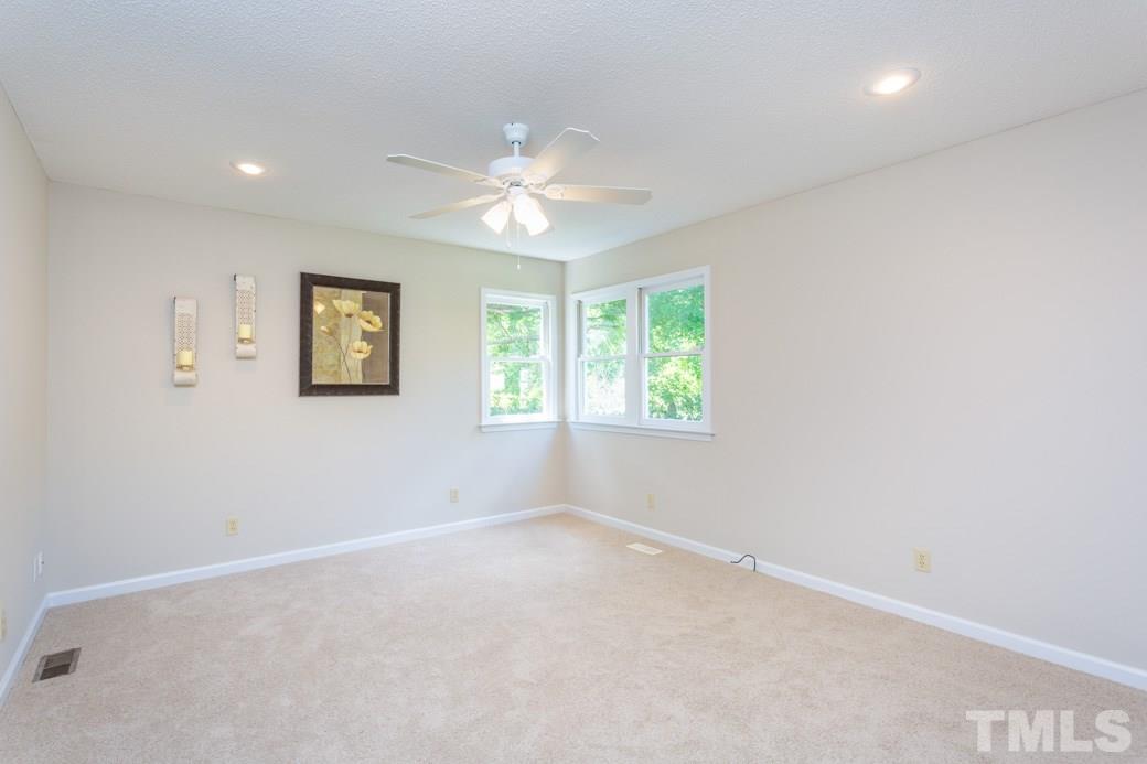 2804 Kempsford Place Raleigh, NC 27604 - Photo 5 of 11 an empty room with windows and fan